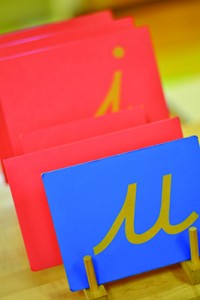 Textured letter tiles reinforce tactile communication. Photo courtesy of Mountain Shadow Montessori.