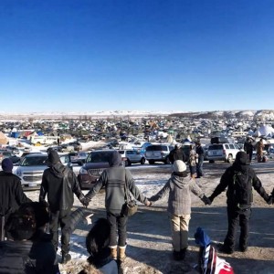 Volunteers hold hands in a line at Standing Rock
