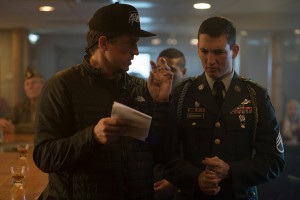 (L to R) Writer/Director JASON HALL and MILES TELLER as Adam Schumann on the set of DreamWorks Pictures’ "Thank You for Your Service." The drama follows a group of U.S. soldiers returning from Iraq who struggle to integrate back into family and civilian life, while living with the memory of a war that threatens to destroy them long after they’ve left the battlefield.