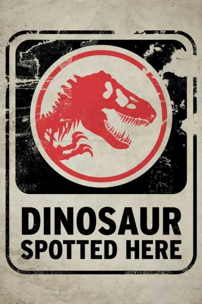 Vintage-style sign featuring a red dinosaur and the words “Dinosaur Spotted Here.”